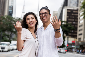 Young Asian Couple Inviting Someone to Come