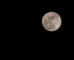 Full moon over dark black sky at night