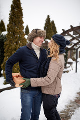 Man is hides box behind his back and going to give his woman a present on Valentine's Day, Christmas or New Year. Boyfriend and girlfriend dating romance. Husband gives gift to wife on her birthday.