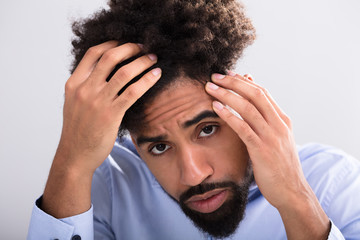 Man Examining His Hair