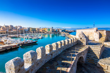 Heraklion harbour with old venetian fort Koule and shipyards, Crete, Greece - obrazy, fototapety, plakaty