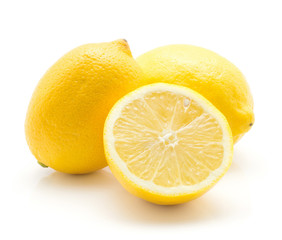Yellow lemons isolated on white background two whole ripe and one cross section half.