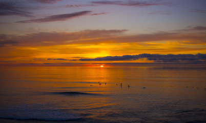 Fototapeta na wymiar Sunset with surfers