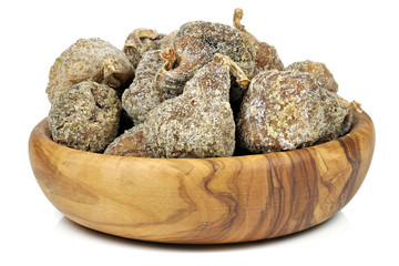 dried figs in a bowl made of olive wood isolated on white background
