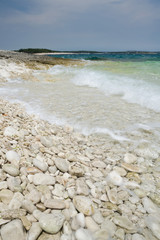 Limestone rocky coast with tide waves