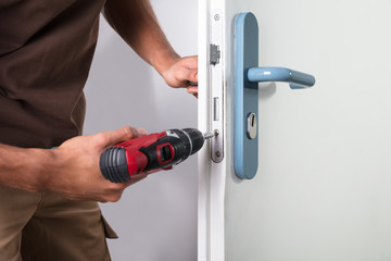 Carpenter Installing Door Lock