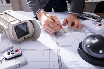 Architect Drawing Plan On Blueprint
