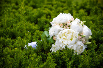 wedding flowers bouquet laying on green grass in park, lifestyle people concept