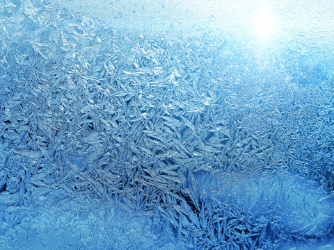 Beautiful ice pattern and sunlight close-up on winter glass