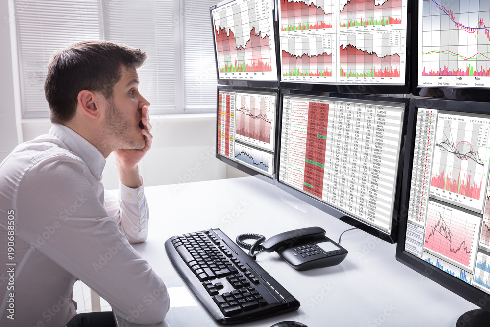 Aufkleber Sad Male Operator Looking At Graphs On Multiple Computer Screen
