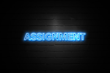 Assignment neon Sign on brickwall