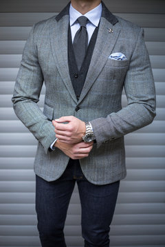 Man In Suit Posing And Fixing His Cufflinks