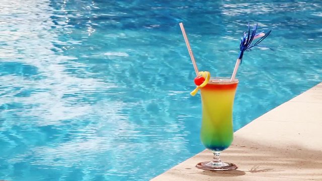 Cocktail "Sex on the beach" against blue water