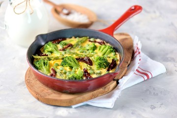 Scrambled eggs with broccoli, asparagus, green peas and sun-dried tomatoes.