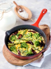 Scrambled eggs with broccoli, asparagus, green peas and sun-dried tomatoes.