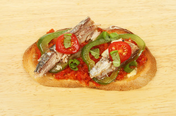 Sardines on toast on a chopping borad