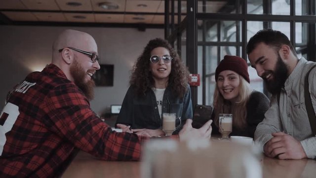 Young people are having fun at the cafe chating, joking, sharing, laughing