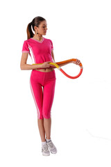 Fitness woman dressed in pink sportswear working with hula hoop. Isolated over white