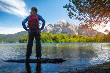 Woman hiker enjoys view of the lake and mountains. Bariloche, Argentina