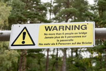 Warning sign about maximal bridge load at foot bridge over Corrieshalloch Gorge and Falls of Measach, Northern Scotland
