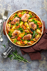 Chicken meat, thighs baked with potato, carrot and green peas