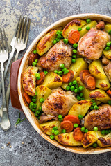 Chicken meat, thighs baked with potato, carrot and green peas