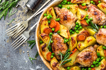 Chicken meat, thighs baked with potato, carrot and green peas