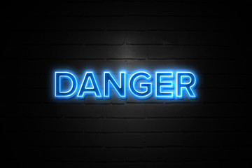 Danger neon Sign on brickwall