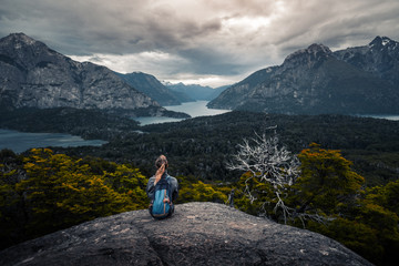 Woman hiker enjoys the valley view from viewpoint. Area near the city of Bariloche, Argentina