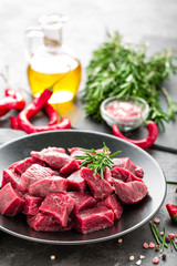 Raw beef meat sliced on black background