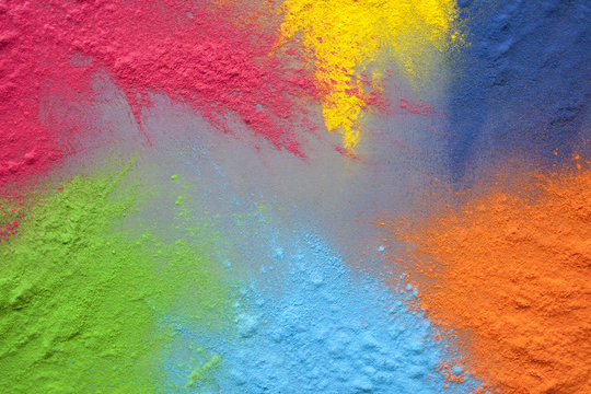 Bright colors for holi festival. Colorful holi paint (powder) splatted on a table with copy space