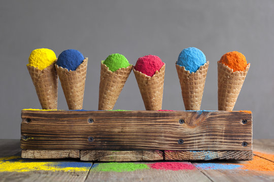 Festival of colors. Bright colours in shapes of ice cream scoops in cones for Indian holi festival. Colorful gulal (powder colors) for Happy Holi. Pigments.