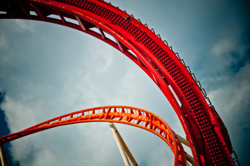 part of a red rolleroster in front of blue sky