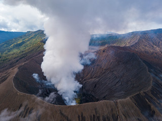 Aerial view to Bromo crater with active volcano smoke in in Bromo Tengger Semeru National Park, East Java, Indonesia.