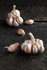 Garlic, Garlic cloves and Garlic bulb in vintage handmade wooden dark table.