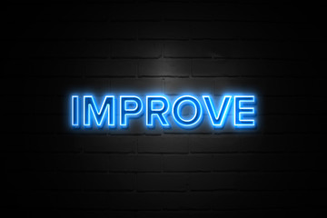 Obraz premium Improve neon Sign on brickwall