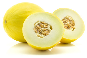 Yellow honeydew melon and two section halves isolated on white background.