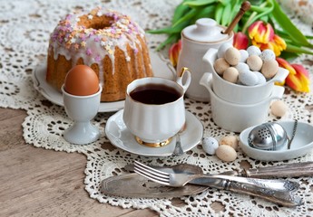 Sliced easter orthodox sweet bread, kulich with white tulips. Breakfast. 