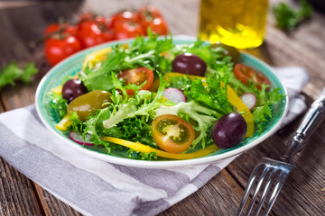 Fresh mixed salad on wooden backgeound
