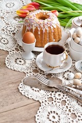 Sliced easter orthodox sweet bread, kulich with white tulips. Breakfast. 