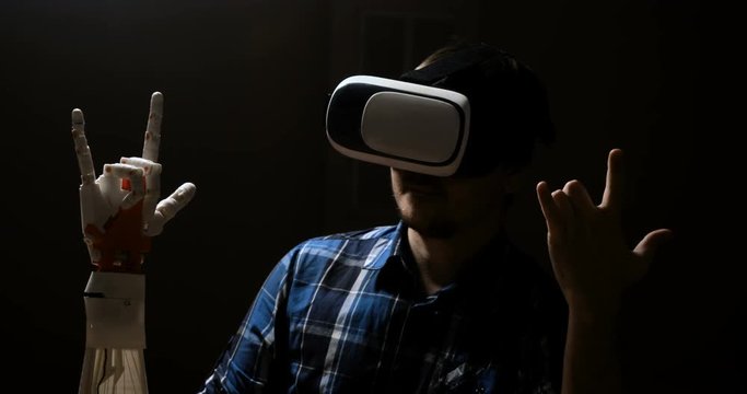 Man with innovative cybernetic system today. Game industry and motion tracking in cyberspace. 360 degree video and display interactive video. Printing on the 3D printer. Sci Fi and plastic prosthetics