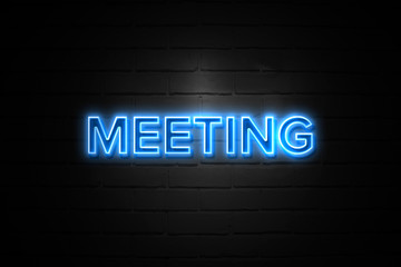 Meeting neon Sign on brickwall
