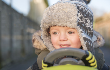One and a half year old boy playing outdoors in winter