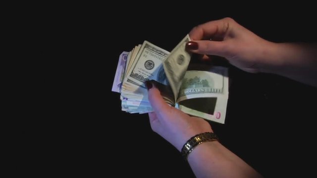 Hands consider monetary banknotes
