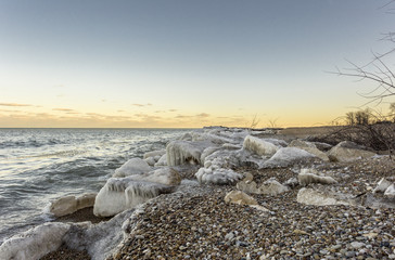 Ice covered rocks on rocky beach