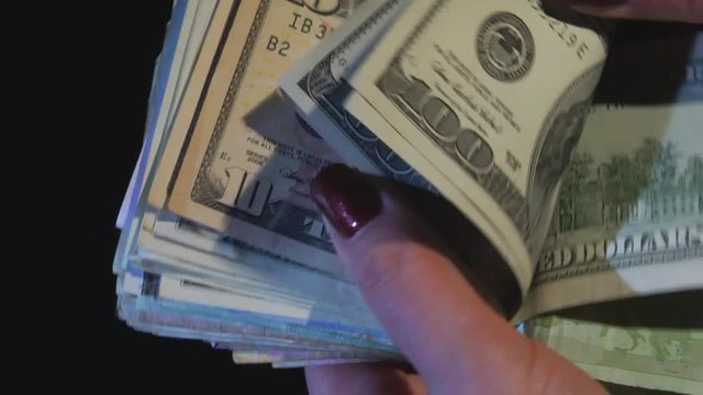 Hands consider monetary banknotes