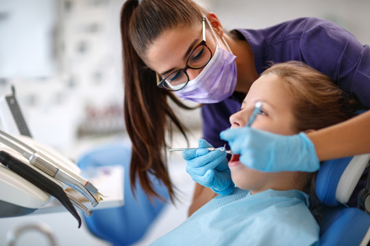 Dentist repairing child's tooth