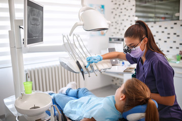 Female dentist working in dental clinic with patient