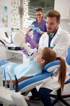 Dentist check up girl's teeth