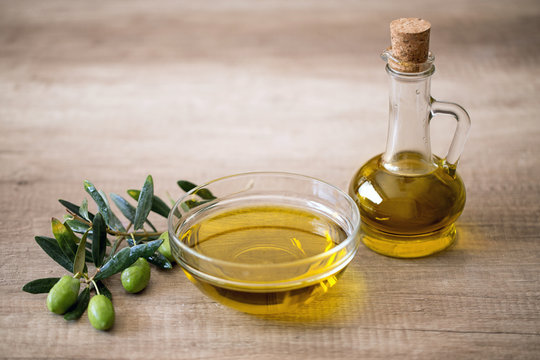 olive oil and olive on wooden background.